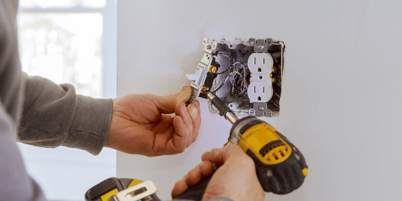 Electrical contractor working inside residential home