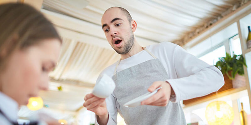 Food and beverage industry accident of employee spilling coffee on customer